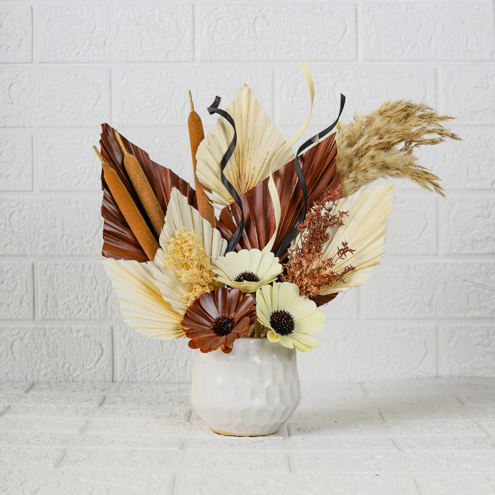 dry flower on white ceramic pot